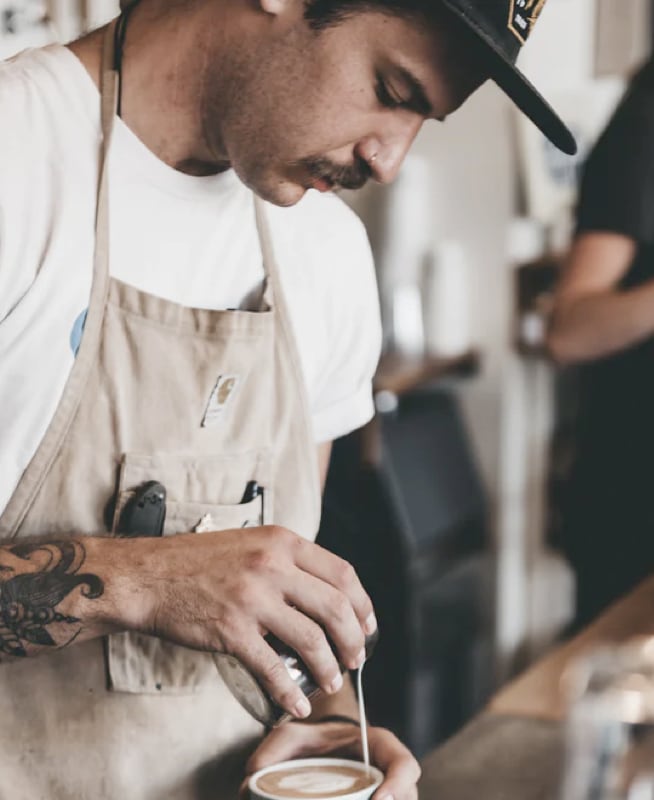 man making coffee latte art